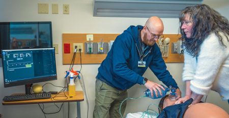 KCC nursing instructors Richard Webb and Margaret Carpenter run through a CPR drill on the new labor and delivery simulator